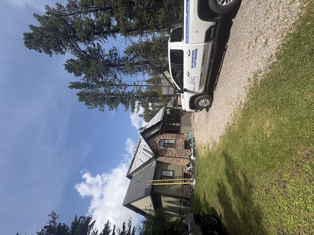Stone-fronted house with the crew truck in the drive