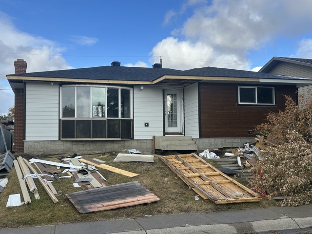 Bungalow with materials on the lawn