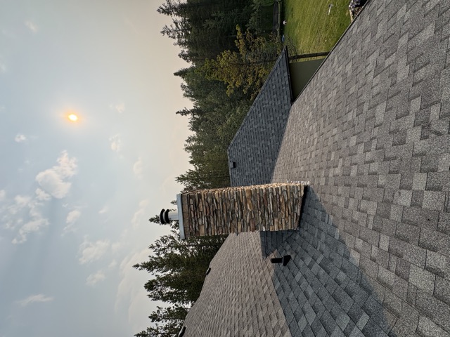 Shingle roof and stone chimney