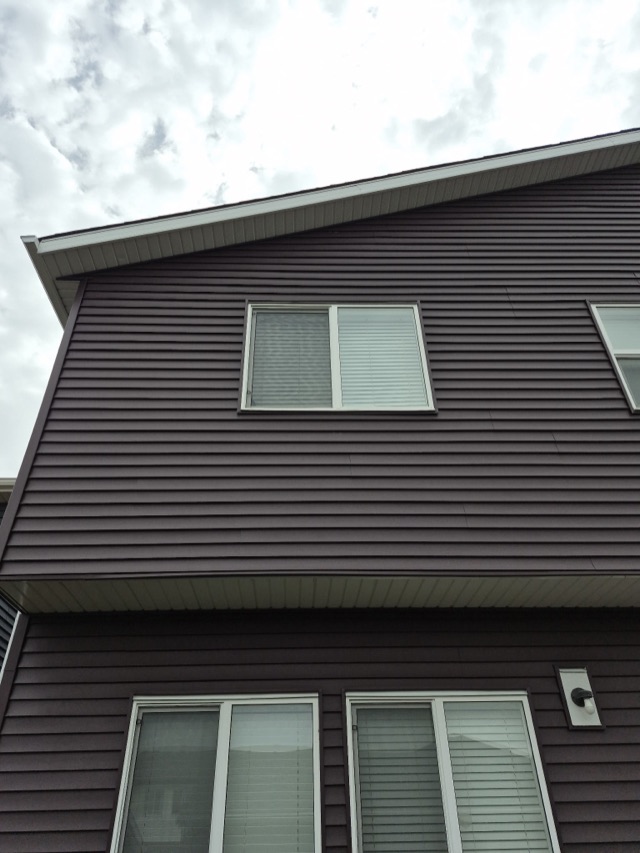 Brown horizontal siding around a window