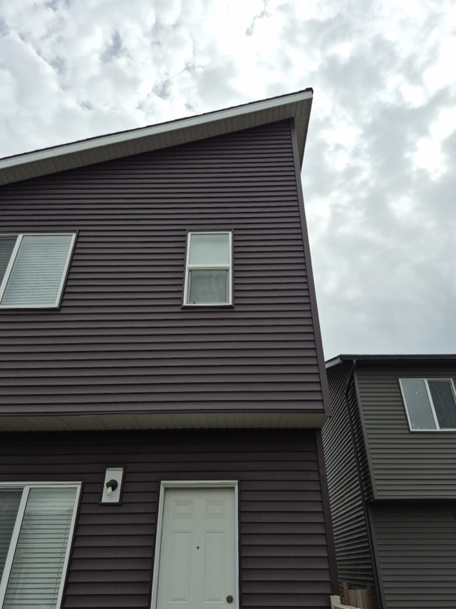 Dark siding with white-trimmed windows